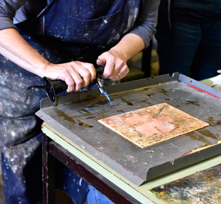 Jo using a blow torch on encaustic painting