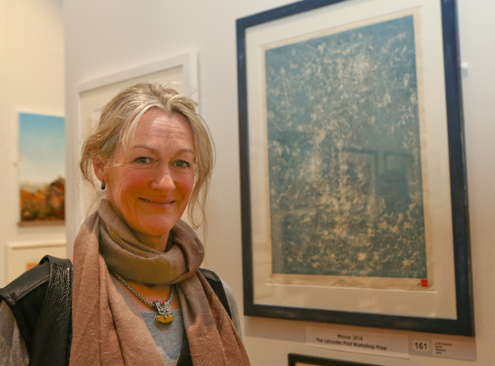 Jo McChesney in front of her prize-winning woodcut