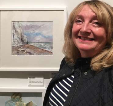 Thumbnail image of Sue Graham&nbsp;with her work at The Open Exhibition - The Open Exhibition