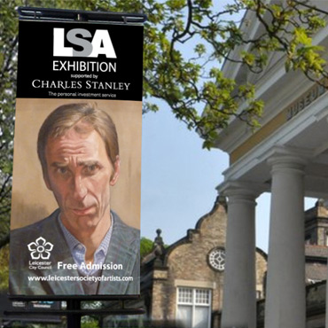 photo outside museum with LSA exhibition banner