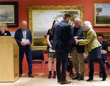 Thumbnail image of Student Award Winner Samson Tudor receiving his prize from sponsors Marck and Gillian Geary of West End Gallery - Preview Evening: LSA Annual Exhibition 2016