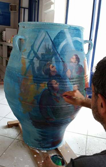 George Sfougaras painting on a decorative vessel Photograph of George Sfougaras working