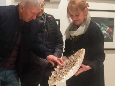 Thumbnail image of Deborah Bird with visitor demonstrating how the paper sculpture is constructed - Meet the LSA Artists at New Walk Museum!