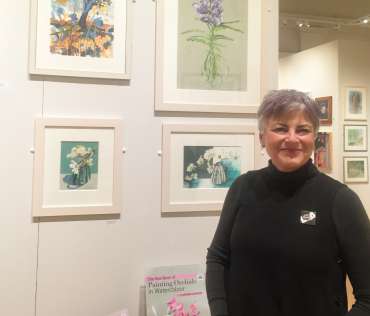 Thumbnail image of Vivienne Cawson in front of two her orchid paintings - Meet the LSA Artists at New Walk Museum!